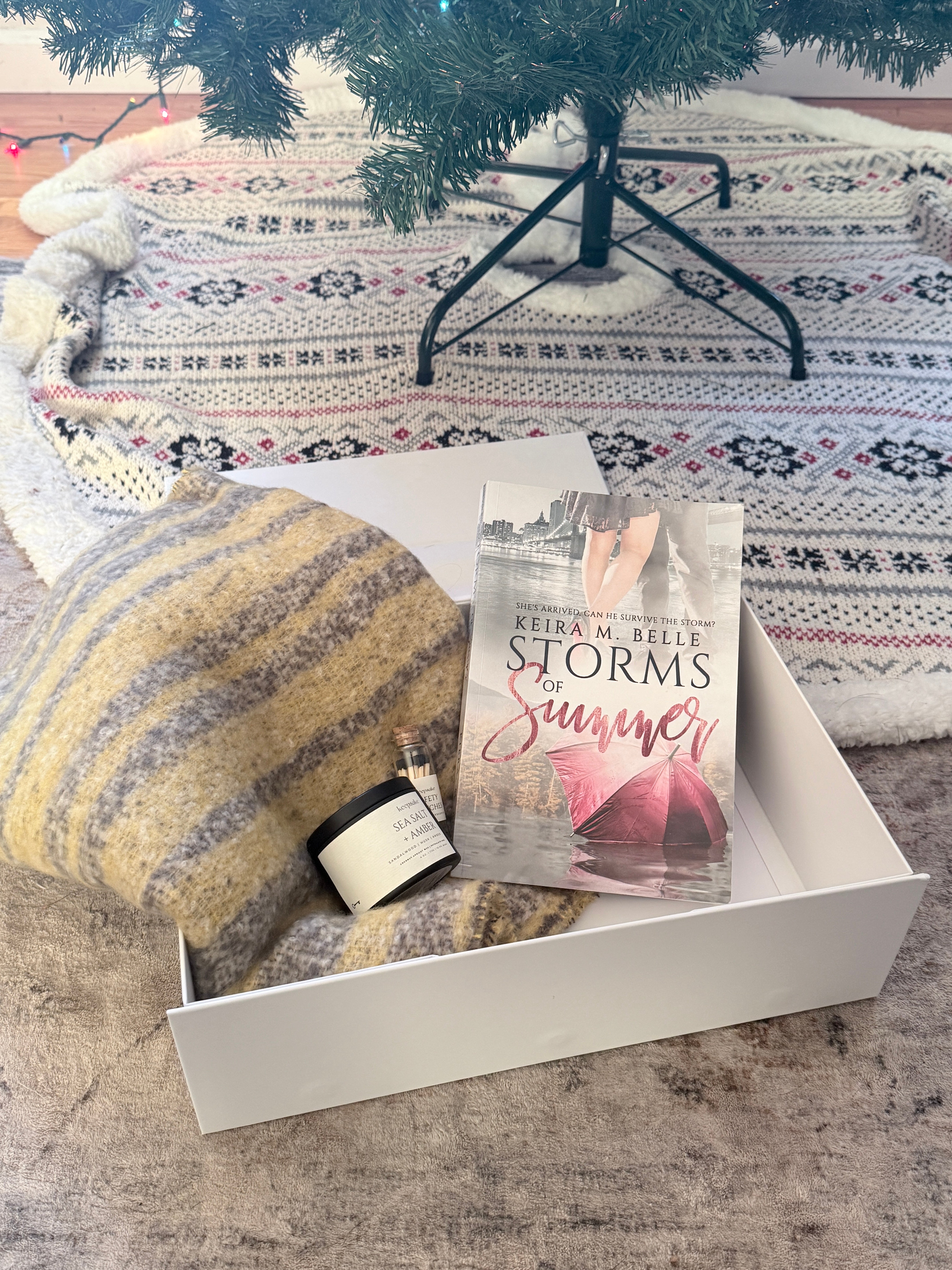 Sage & Arrow Holiday Gift Box with a book, candle, matches, and a cozy winter scarf