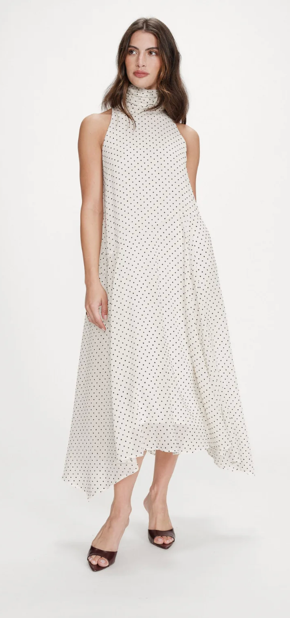 Woman wearing a polka dot dress on a white background